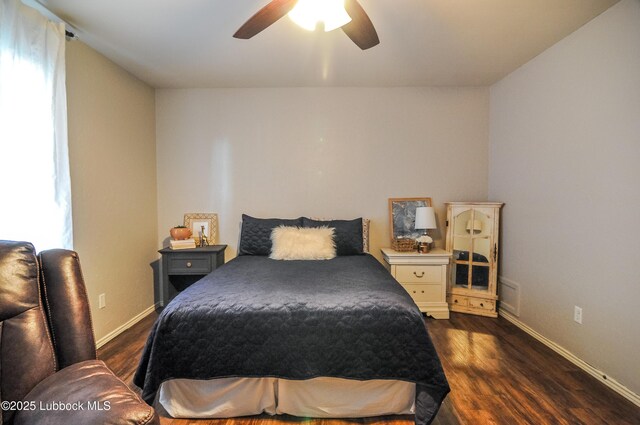 5309 77th St, Lubbock, TX 79424 - bedroom featuring dark wood finished floors, baseboards, and a ceiling fan