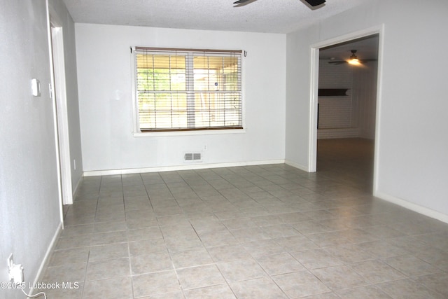 3707 38th St, Lubbock, TX 79413 - empty room featuring a ceiling fan, light tile patterned flooring, and a textured ceiling