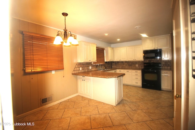 3707 38th St, Lubbock, TX 79413 - kitchen with black appliances, backsplash, a peninsula, a chandelier, and light tile patterned flooring