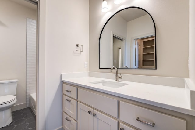 bathroom with tile patterned flooring, vanity, and toilet