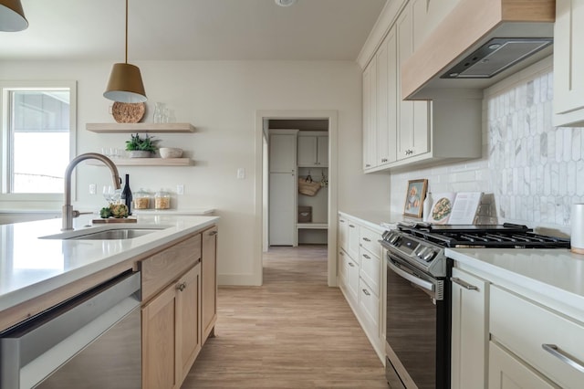 kitchen with sink, appliances with stainless steel finishes, hanging light fixtures, custom exhaust hood, and light brown cabinets