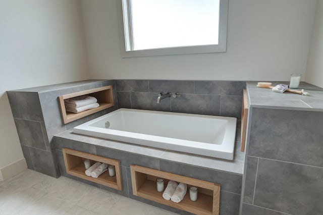 bathroom with tile patterned flooring and a bathing tub