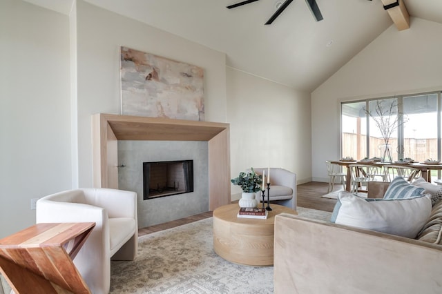 living room featuring lofted ceiling with beams, ceiling fan, and light hardwood / wood-style flooring