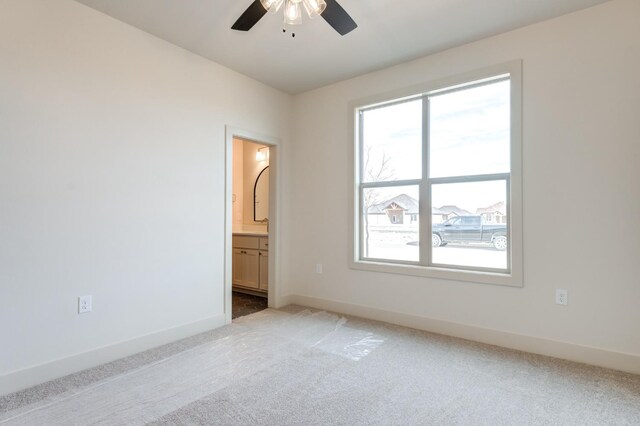 unfurnished room with carpet and ceiling fan