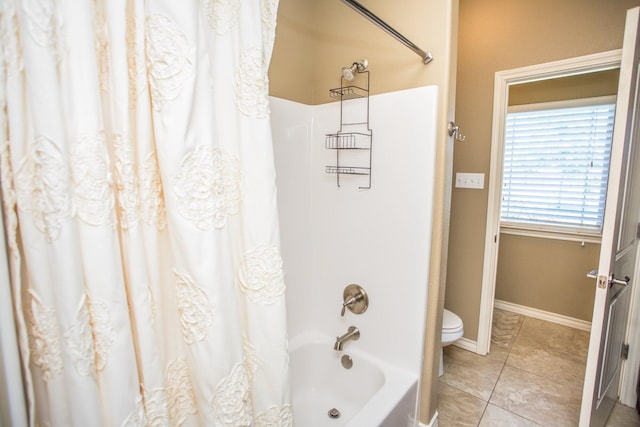 bathroom with tile patterned floors, shower / bath combo with shower curtain, baseboards, and toilet