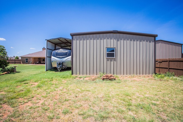 exterior space with a carport and fence