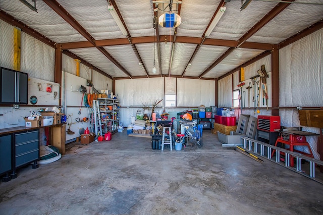 garage with a garage door opener and a workshop area