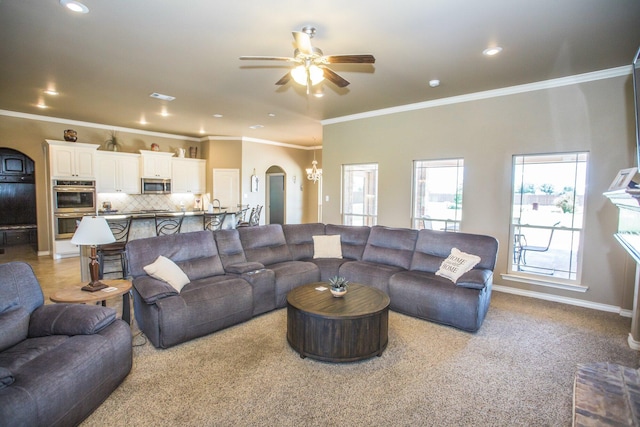 living area featuring ceiling fan, arched walkways, ornamental molding, recessed lighting, and carpet floors