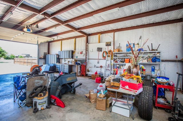 garage featuring a garage door opener and a workshop area