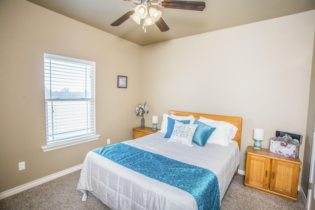 carpeted bedroom with baseboards, multiple windows, and ceiling fan