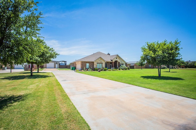 view of front of property featuring an outbuilding, a front lawn, a garage, and concrete driveway