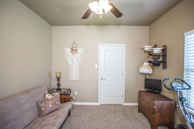 living area featuring carpet floors, ceiling fan, a wealth of natural light, and baseboards