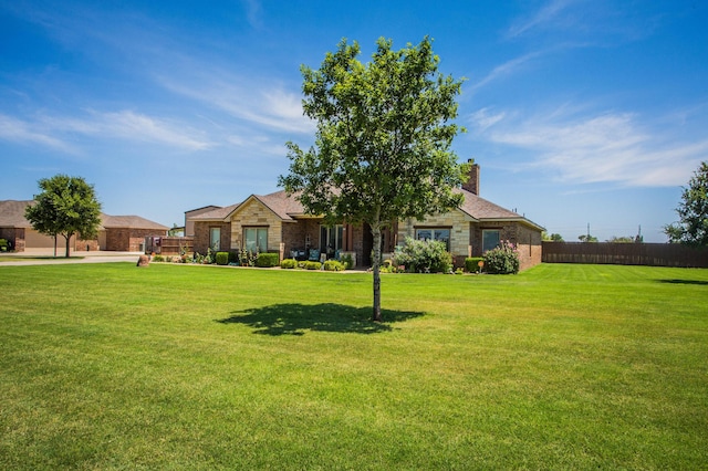 view of front facade featuring stone siding and a front lawn