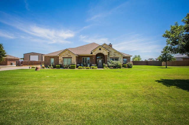 ranch-style home featuring stone siding, fence, a front lawn, and a chimney