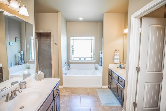 bathroom with two vanities, a sink, tile patterned flooring, a bath, and a tile shower