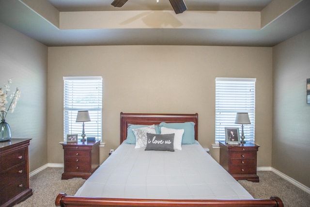carpeted bedroom featuring baseboards and ceiling fan