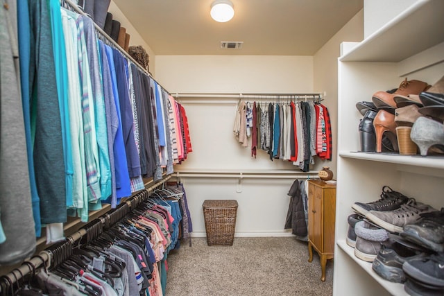 spacious closet featuring visible vents and carpet floors