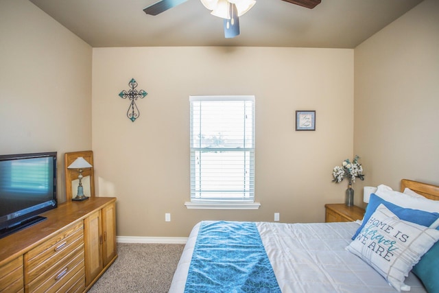 carpeted bedroom with baseboards and a ceiling fan