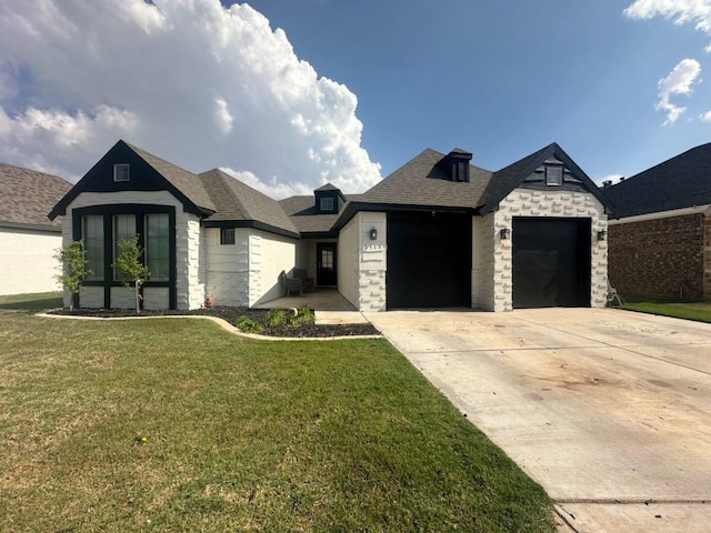 view of front of home with a garage and a front lawn