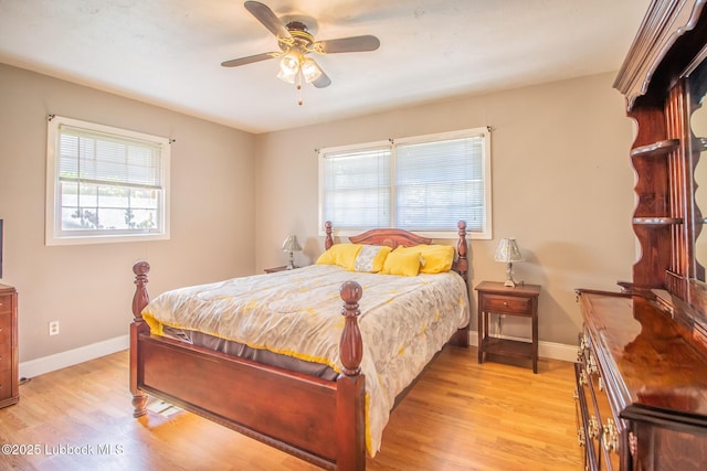 3404 59th St, Lubbock, TX 79413 - bedroom with multiple windows, light wood-type flooring, baseboards, and a ceiling fan