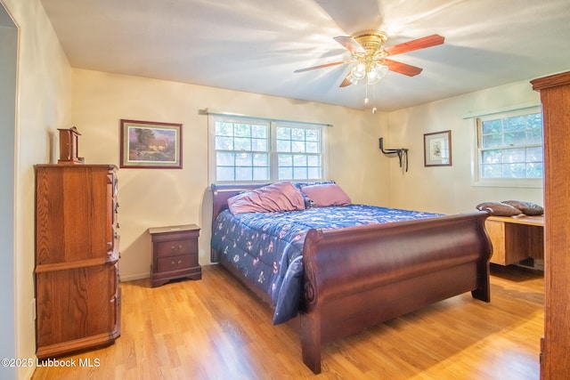 3404 59th St, Lubbock, TX 79413 - bedroom with wood finished floors, multiple windows, a ceiling fan, and baseboards