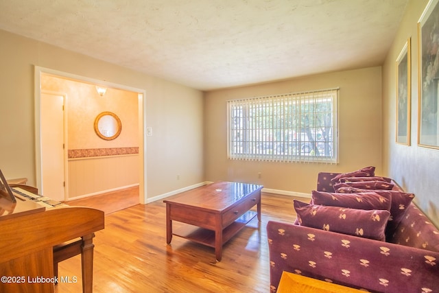 3404 59th St, Lubbock, TX 79413 - living room with wood finished floors, a textured ceiling, and baseboards