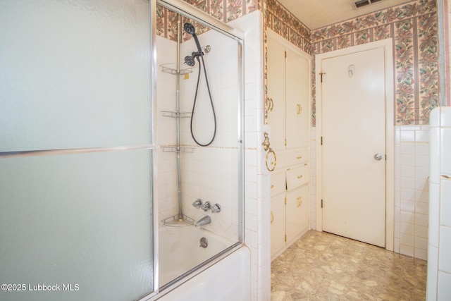3404 59th St, Lubbock, TX 79413 - bathroom with wallpapered walls and combined bath / shower with glass door