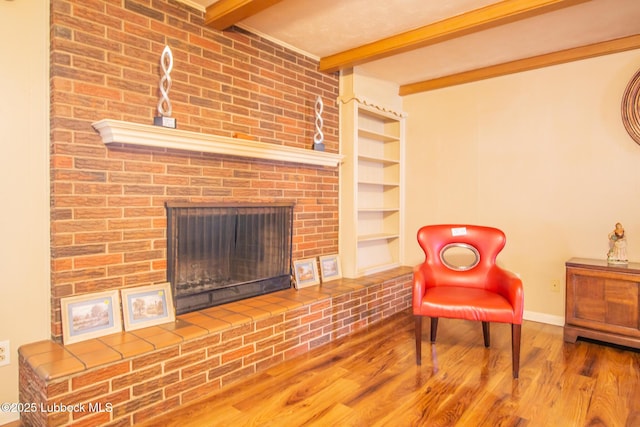 3404 59th St, Lubbock, TX 79413 - living area with wood finished floors, baseboards, beamed ceiling, a fireplace, and built in features