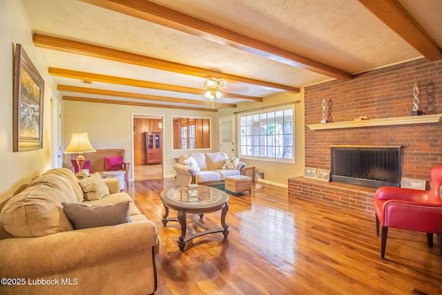 3404 59th St, Lubbock, TX 79413 - living room featuring beam ceiling, baseboards, wood finished floors, and a fireplace