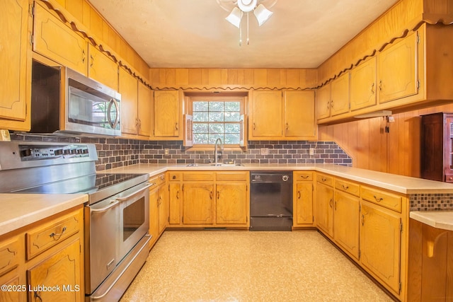 3404 59th St, Lubbock, TX 79413 - kitchen with appliances with stainless steel finishes, a sink, tasteful backsplash, and light countertops