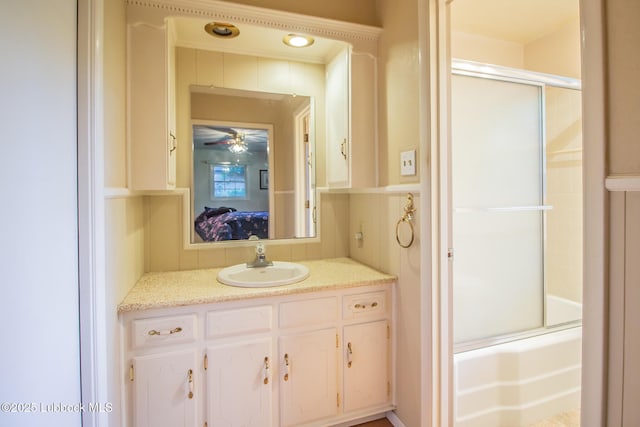 3404 59th St, Lubbock, TX 79413 - ensuite bathroom with combined bath / shower with glass door, vanity, and ceiling fan