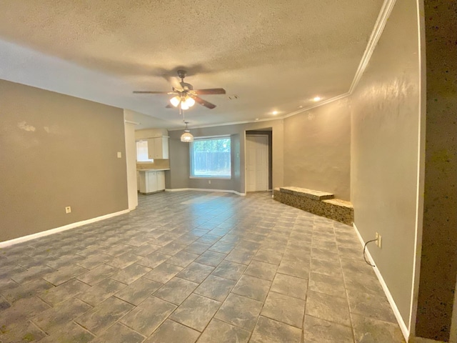 unfurnished living room with ceiling fan, a textured ceiling, and crown molding