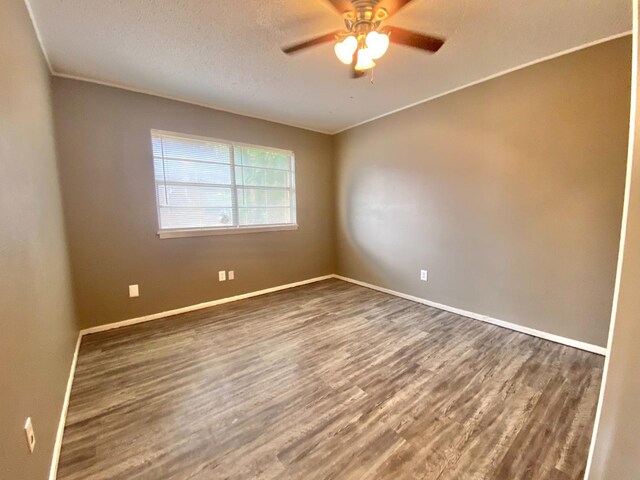 unfurnished room featuring hardwood / wood-style flooring, ceiling fan, a textured ceiling, and crown molding