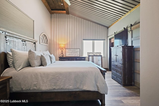 743 Co Rd, M, Tahoka, TX 79373 - bedroom with a barn door, high vaulted ceiling, wood finished floors, and wood ceiling