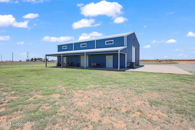 743 Co Rd, M, Tahoka, TX 79373 - rear view of property featuring a lawn, central AC, and a patio area