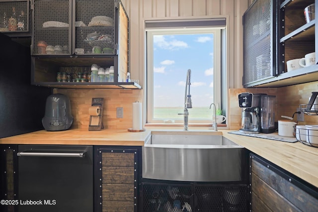 743 Co Rd, M, Tahoka, TX 79373 - kitchen featuring a sink, wooden counters, and glass insert cabinets