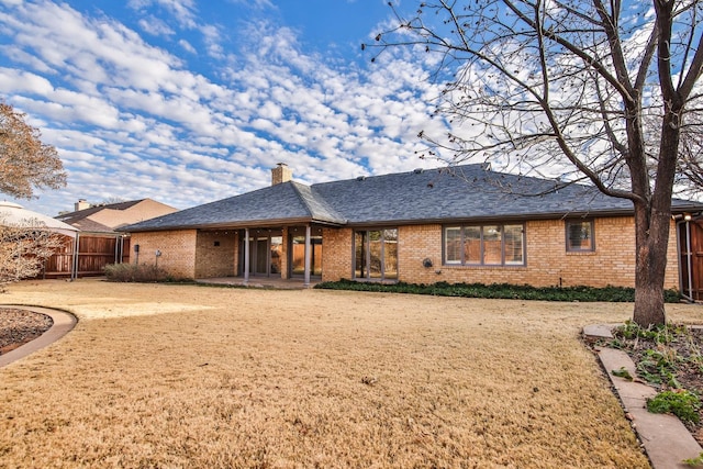 rear view of property with a yard