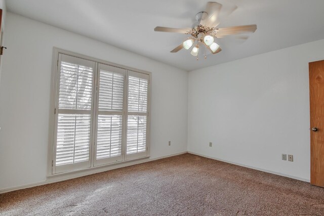 unfurnished room featuring ceiling fan and carpet floors