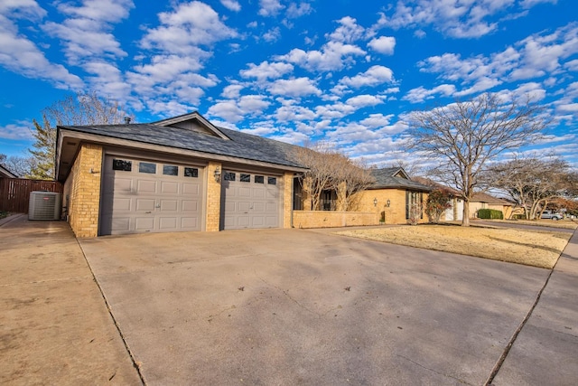 ranch-style house with central AC and a garage