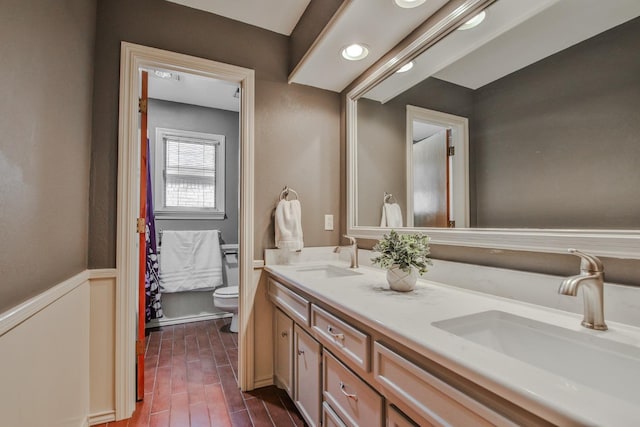 bathroom with vanity, toilet, and wood-type flooring