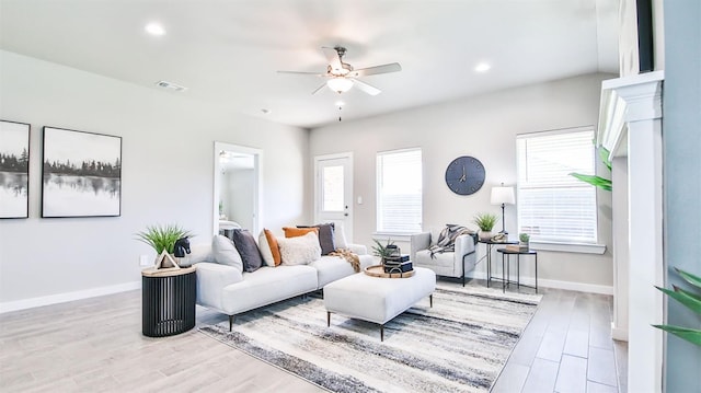 living room featuring ceiling fan and light wood-type flooring