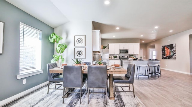 dining space featuring a wealth of natural light and light wood-type flooring