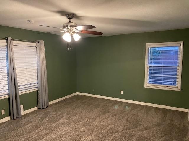 carpeted spare room with ceiling fan