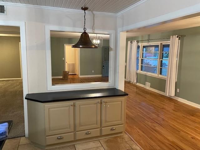 interior space with wood ceiling, ornamental molding, and light hardwood / wood-style flooring