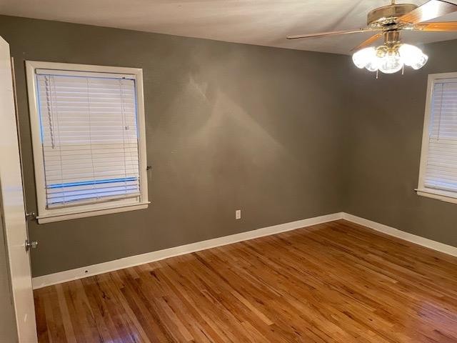 spare room featuring ceiling fan and hardwood / wood-style floors