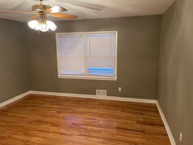 unfurnished room with wood-type flooring and ceiling fan