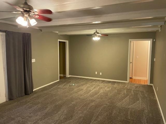 carpeted spare room featuring beam ceiling and ceiling fan