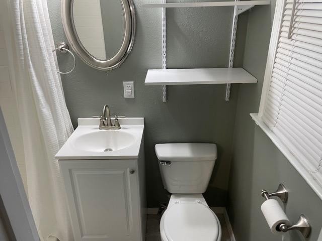 bathroom featuring vanity and toilet