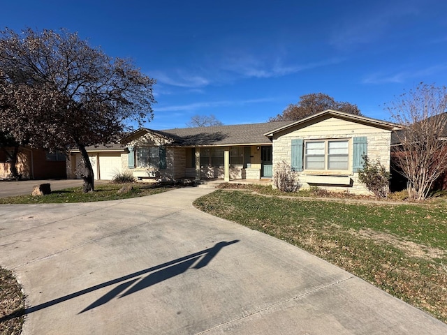 single story home featuring a garage and a front lawn