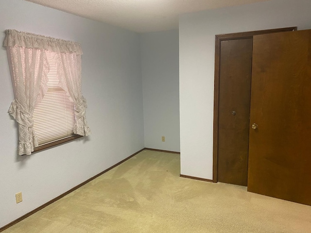 unfurnished bedroom featuring light colored carpet